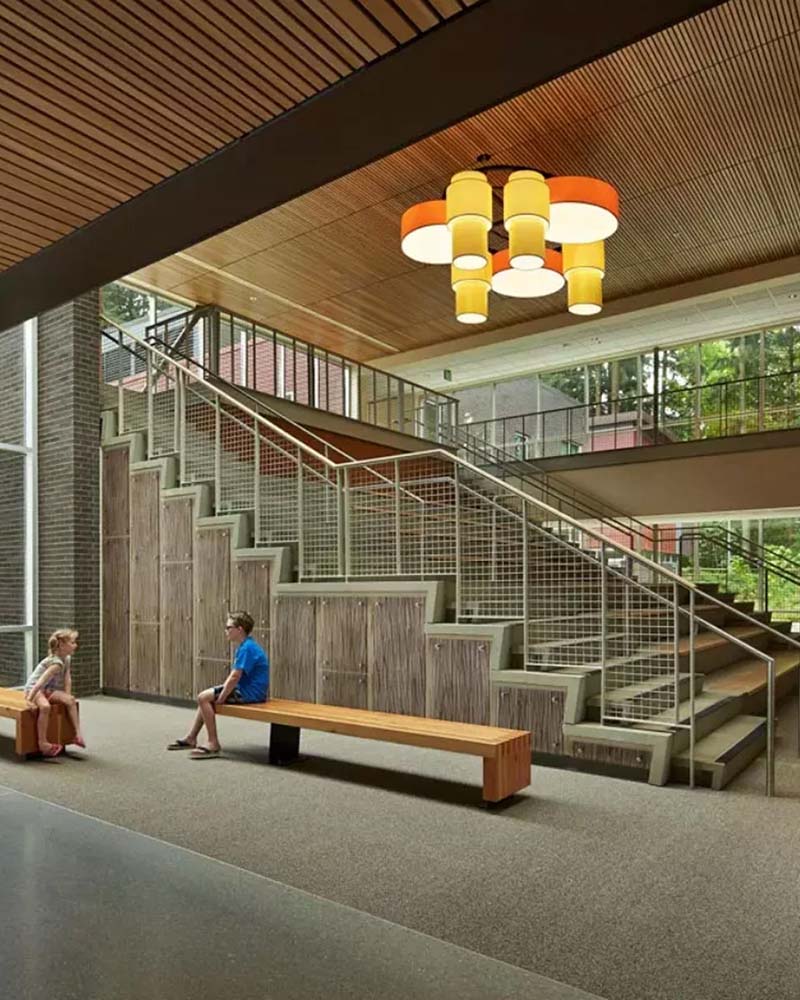 Large open stairwell with colorful drum pendant light overhead